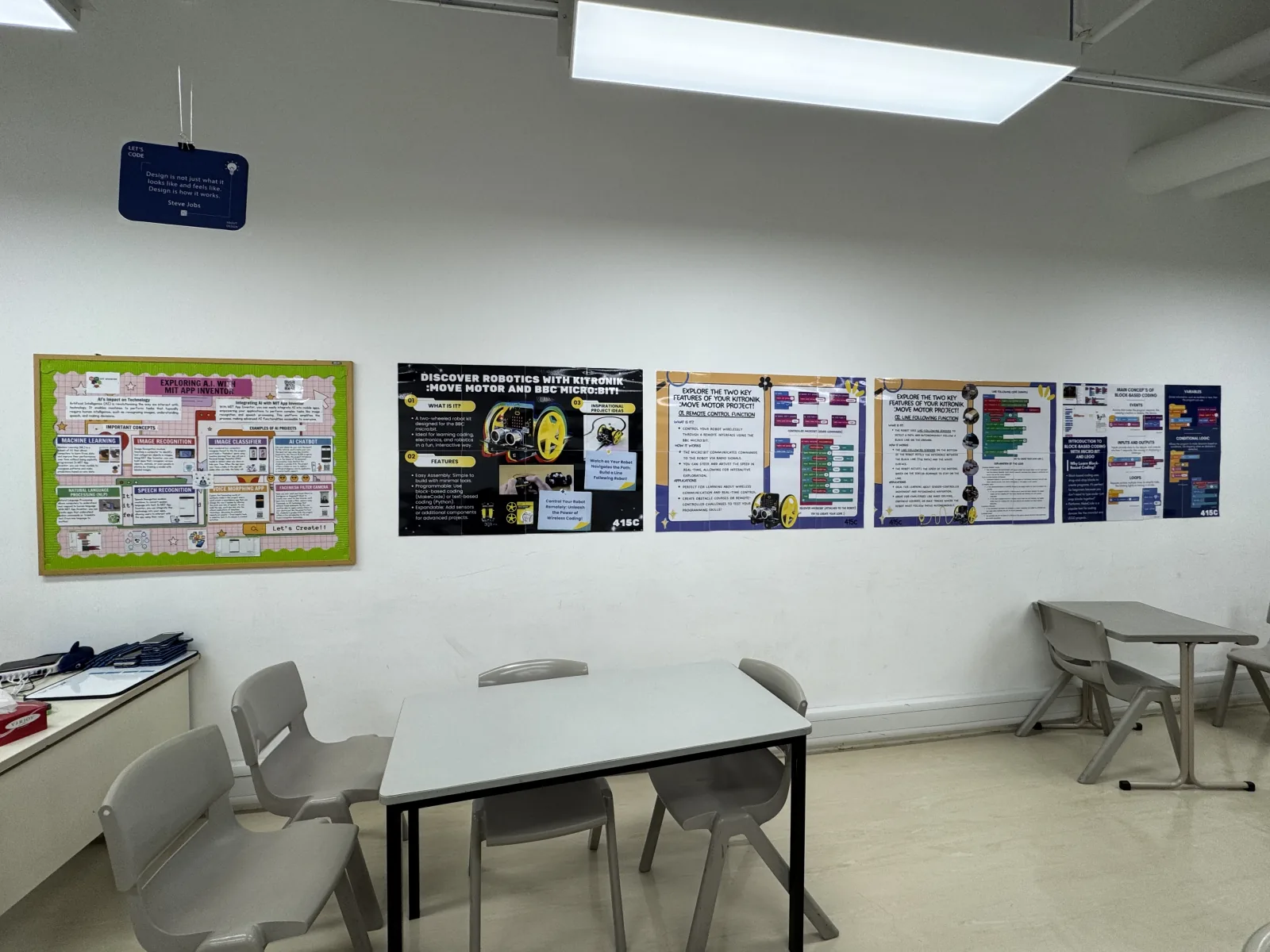 A classroom robotics learning wall with student-designed coding and troubleshooting posters.